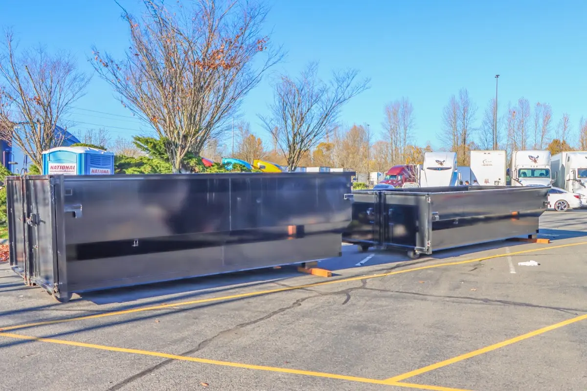 Professional dumpster rental service with roll-off container on residential driveway in Leoni